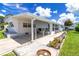 Beautiful home exterior featuring a covered patio, landscaped garden beds, and a well-kept lawn with a concrete driveway at 508 50Th Avenue W Plz, Bradenton, FL 34207