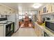 Cozy kitchen with updated appliances, white cabinets, and an open view to the adjacent dining and living areas at 508 50Th Avenue W Plz, Bradenton, FL 34207