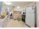 Traditional kitchen featuring white cabinets, updated appliances, and ample counter space with an open view to other rooms at 508 50Th Avenue W Plz, Bradenton, FL 34207