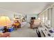 Bright living room with plush seating, a sewing machine, and large windows, offering a versatile space at 508 50Th Avenue W Plz, Bradenton, FL 34207