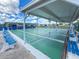 Shuffleboard courts with blue bench seating available for community members in a shady covered area at 508 50Th Avenue W Plz, Bradenton, FL 34207