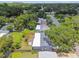 Aerial view of home showcasing fenced backyard, roof, and surrounding trees at 528 Manor Dr, Dunedin, FL 34698