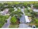A high angle of a single-Gathering home featuring a wooden pergola and landscaped yard at 528 Manor Dr, Dunedin, FL 34698