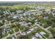An aerial view of a quiet residential neighborhood with mature trees and convenient shopping nearby at 528 Manor Dr, Dunedin, FL 34698