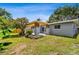Backyard featuring a patio with pergola, grassy lawn and a privacy fence at 528 Manor Dr, Dunedin, FL 34698