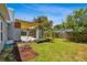 Spacious backyard featuring a pergola, grassy area, and mature trees at 528 Manor Dr, Dunedin, FL 34698
