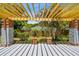 Beautiful backyard patio with wooden pergola and brick pillars, overlooking the garden at 528 Manor Dr, Dunedin, FL 34698