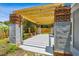 Backyard patio with pergola, featuring brick pillars and a concrete floor, perfect for outdoor entertaining at 528 Manor Dr, Dunedin, FL 34698