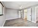 Bright bedroom view showing closet, bathroom, and hall doorways along with a ceiling fan at 528 Manor Dr, Dunedin, FL 34698