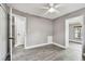 Neutral bedroom showcasing light gray walls and wood-look floors and doors to other rooms at 528 Manor Dr, Dunedin, FL 34698