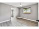 Neutral bedroom showcasing light gray walls and wood-look floors and a single window at 528 Manor Dr, Dunedin, FL 34698