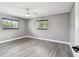 Spacious bedroom with two windows providing natural light and modern vinyl floors at 528 Manor Dr, Dunedin, FL 34698