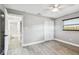 Bedroom featuring closet, doorway to bathroom, ceiling fan and natural light from window at 528 Manor Dr, Dunedin, FL 34698