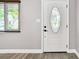 Close-up of the front door showcasing decorative glass, new flooring, and a modern aesthetic at 528 Manor Dr, Dunedin, FL 34698