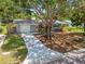 Charming home featuring a driveway, well-manicured lawn, and mature trees at 528 Manor Dr, Dunedin, FL 34698