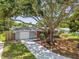 Charming home featuring a driveway, well-manicured lawn, and mature trees at 528 Manor Dr, Dunedin, FL 34698