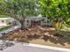 Home featuring a well-manicured front yard with mature landscaping at 528 Manor Dr, Dunedin, FL 34698