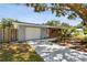 Charming single-story home featuring a long driveway and brick facade at 528 Manor Dr, Dunedin, FL 34698