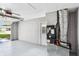 Spacious garage with white walls and door leading to outside; a utility system on the right at 528 Manor Dr, Dunedin, FL 34698