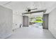 Bright, open garage with visible driveway and landscaping through the opened garage door at 528 Manor Dr, Dunedin, FL 34698