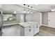Bright, open kitchen with an island, granite countertops, stainless appliances, and an open-concept layout at 528 Manor Dr, Dunedin, FL 34698
