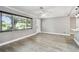 Light-filled living room featuring a large window, new floors, and seamless flow to the adjacent kitchen at 528 Manor Dr, Dunedin, FL 34698