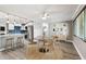 Bright, open living room showcasing a dining area with modern furnishings and a view into the updated kitchen at 528 Manor Dr, Dunedin, FL 34698