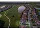 An aerial view showcases this home on a golf course community with a serene lake at 5804 Mulligan Way, Lakewood Ranch, FL 34211