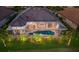 Aerial view of the screened in-ground pool and hardscape, complimented by a lush green lawn and landscape at 5804 Mulligan Way, Lakewood Ranch, FL 34211
