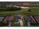 Aerial view of home on golf course, featuring paver driveway, mature trees and manicured lawns at 5804 Mulligan Way, Lakewood Ranch, FL 34211