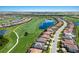 Overhead view showcasing the beautiful community layout with homes nestled around a golf course and scenic lake at 5804 Mulligan Way, Lakewood Ranch, FL 34211