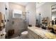 Beautiful bathroom with a glass-enclosed shower, granite countertop, and neutral tiling at 5804 Mulligan Way, Lakewood Ranch, FL 34211