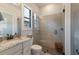 Bright bathroom with a glass shower, granite countertop, and a large window at 5804 Mulligan Way, Lakewood Ranch, FL 34211