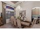 Elegant dining room with chandelier, arched window, and beverage center at 5804 Mulligan Way, Lakewood Ranch, FL 34211