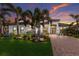 Lovely home featuring tropical landscaping, stone accents, and a paver driveway at 5804 Mulligan Way, Lakewood Ranch, FL 34211