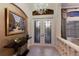 The foyer boasts a decorative chandelier, elegant console table, and stone tile floor at 5804 Mulligan Way, Lakewood Ranch, FL 34211