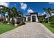 Home exterior featuring a well-manicured lawn, and a paved driveway at 5804 Mulligan Way, Lakewood Ranch, FL 34211