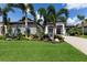 Beautiful lush tropical landscaping and palm trees enhance curb appeal at 5804 Mulligan Way, Lakewood Ranch, FL 34211