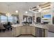 Open kitchen with a granite island, stainless steel appliances, and views of the living area at 5804 Mulligan Way, Lakewood Ranch, FL 34211