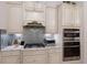 Detailed shot of the kitchen featuring cabinetry, backsplash, and stainless appliances at 5804 Mulligan Way, Lakewood Ranch, FL 34211