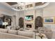 Comfortable living room with fireplace, display cabinets, and luxurious seating at 5804 Mulligan Way, Lakewood Ranch, FL 34211