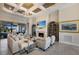 Spacious living room with a fireplace, coffered ceilings, and access to the outdoors at 5804 Mulligan Way, Lakewood Ranch, FL 34211