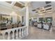 Open-concept living room featuring coffered ceilings, chandelier and tile flooring at 5804 Mulligan Way, Lakewood Ranch, FL 34211