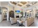 Open-concept living room with a fireplace, comfortable seating, and elegant decor at 5804 Mulligan Way, Lakewood Ranch, FL 34211