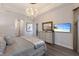 Comfortable main bedroom with hardwood floors, an ensuite, and a TV at 5804 Mulligan Way, Lakewood Ranch, FL 34211