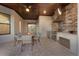 Outdoor kitchen under the patio featuring stainless steel appliances and a brick backsplash at 5804 Mulligan Way, Lakewood Ranch, FL 34211