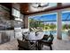 Inviting outdoor kitchen featuring stainless steel appliances, brick accents, and a dining area overlooking the pool at 5804 Mulligan Way, Lakewood Ranch, FL 34211