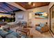 Outdoor living area featuring comfortable seating, a TV, and access to a pool and spa at 5804 Mulligan Way, Lakewood Ranch, FL 34211