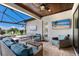 Inviting outdoor patio with comfortable seating, a ceiling fan, and a serene view at 5804 Mulligan Way, Lakewood Ranch, FL 34211