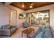 Inviting covered patio featuring comfortable seating, a ceiling fan, and a view into the living room at 5804 Mulligan Way, Lakewood Ranch, FL 34211